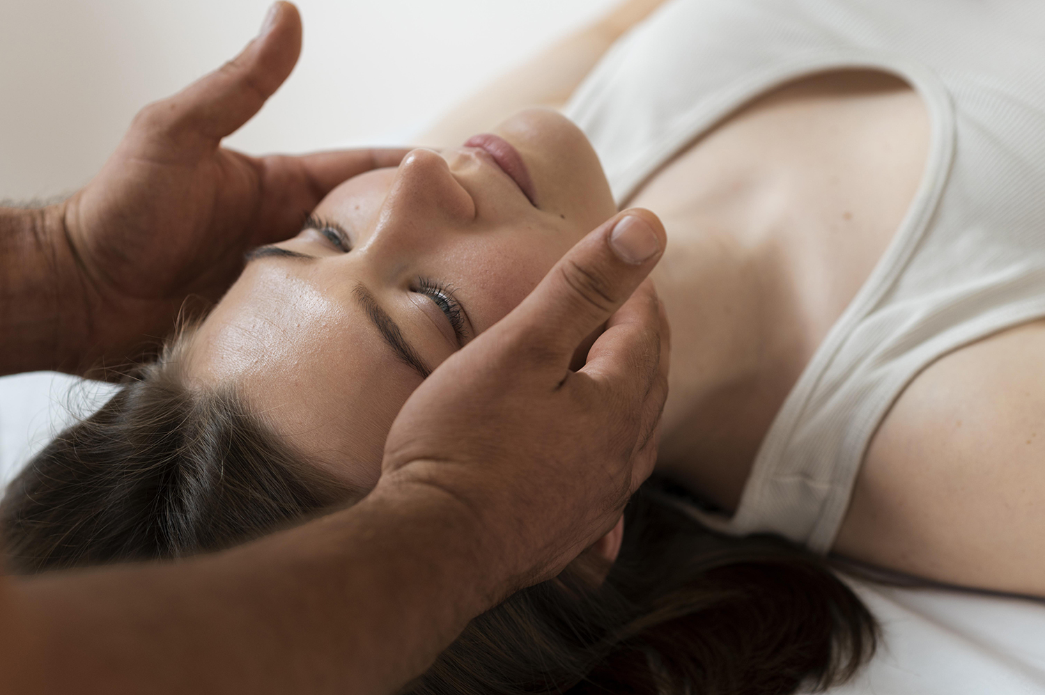 professional female physiotherapist giving shoulder massage to blonde woman